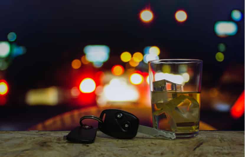 An alcoholic drink next to car keys, representing a DUI