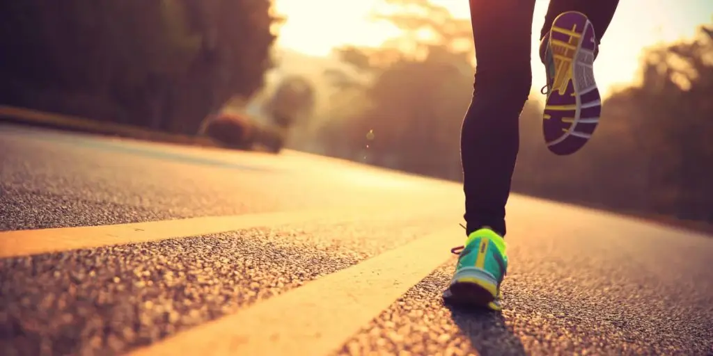 women walking along a yellow line in the road
