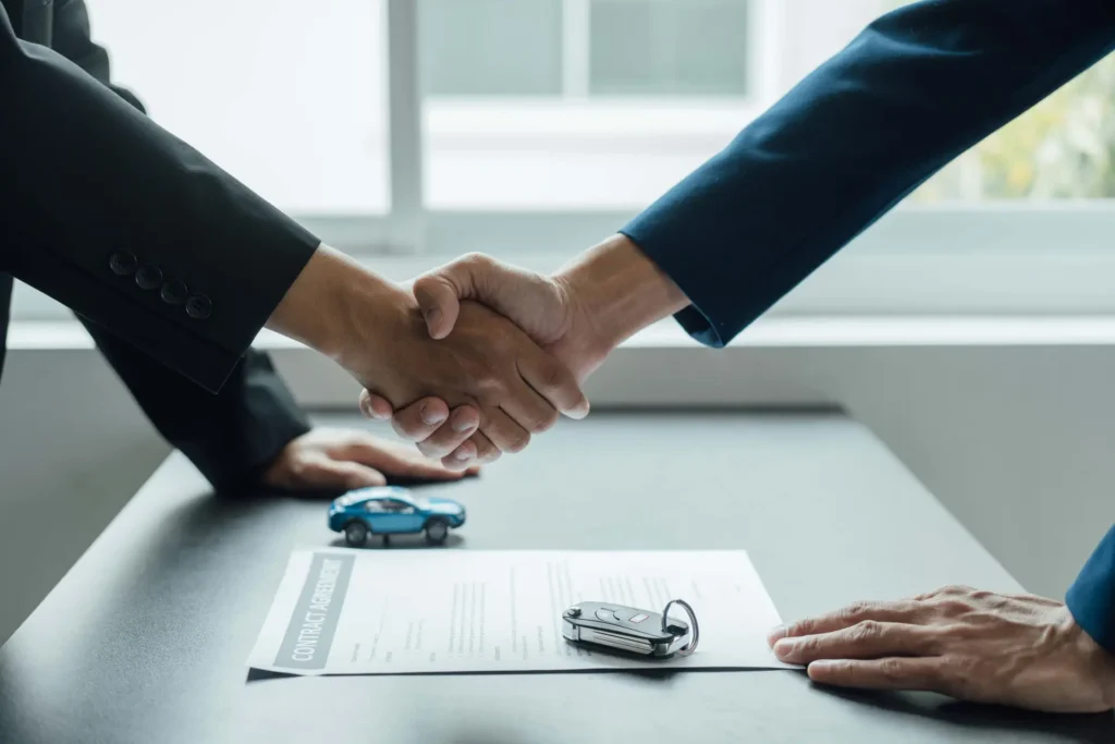 a man shaking hands with a car crash lawyer after an contract agreement