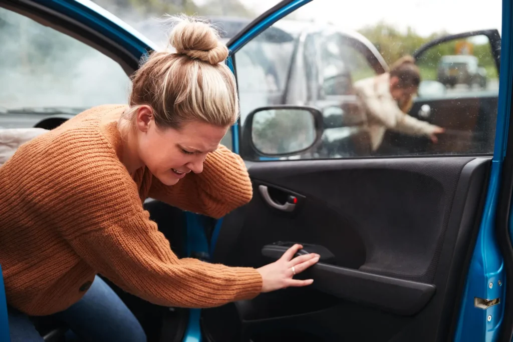 a Woman Getting Out of a Car and Experiencing The Emotional Impact of Personal Injury