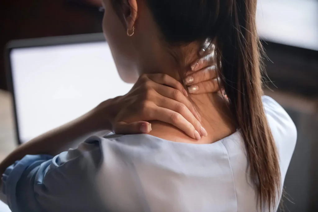 women holding her neck with a preexisting condition
