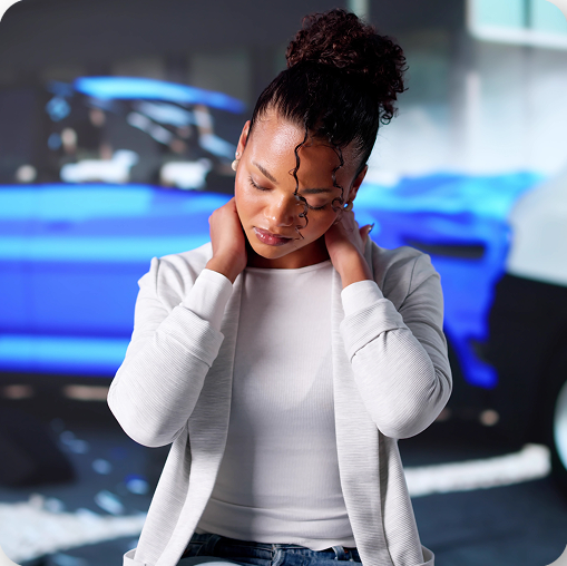 Woman with neck pain and blurred background of defective products, Tucson personal injury claim.