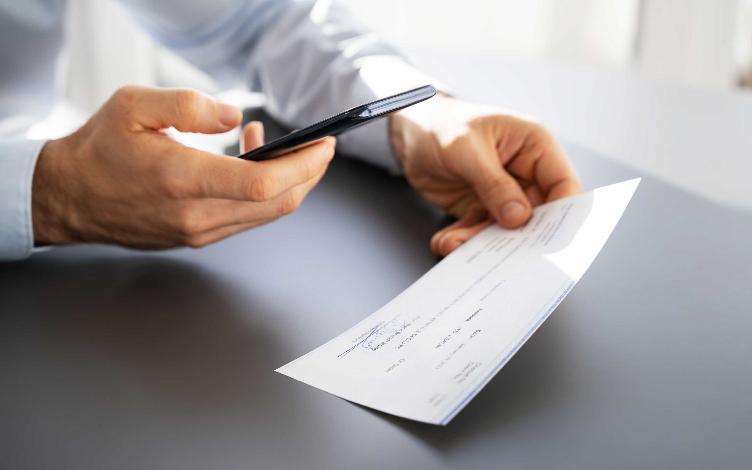Person reviewing medical paperwork and a payment document, illustrating medical liens in Arizona.
