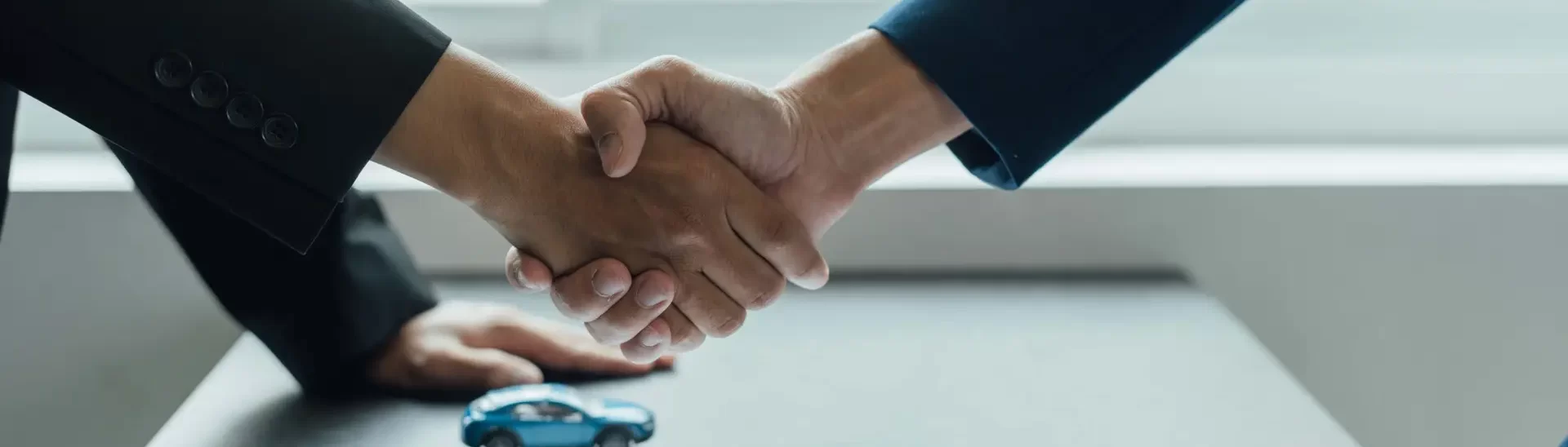 a man shaking hands with a car crash lawyer after an contract agreement