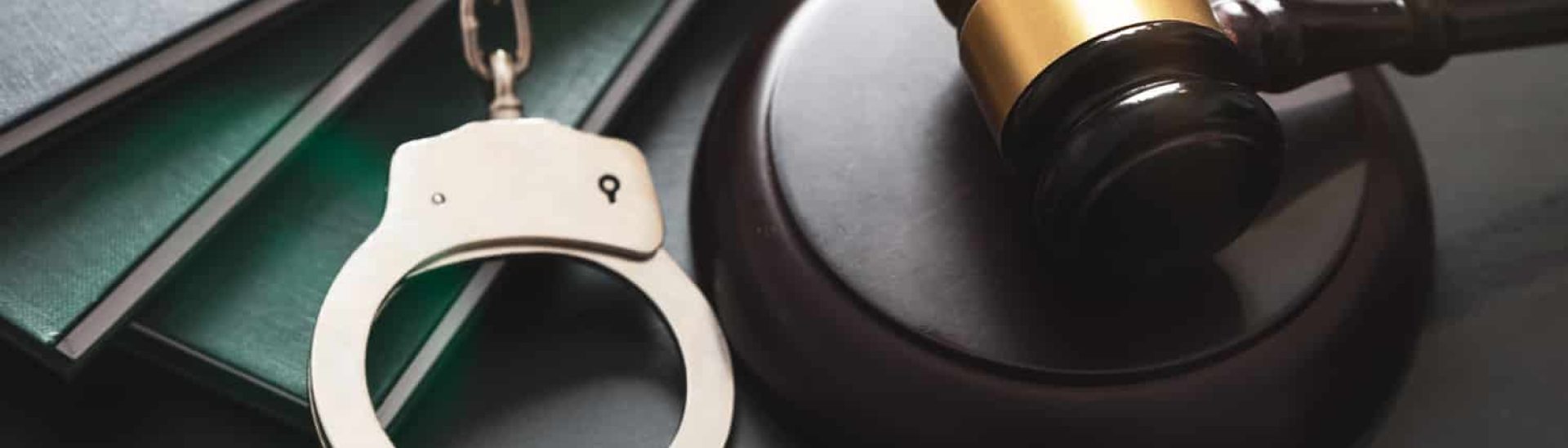 A gavel and handcuffs, representing the question of who is required to register as a sex offender in Arizona
