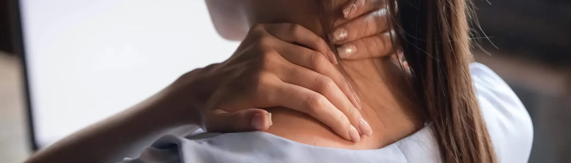 women holding her neck with a preexisting condition