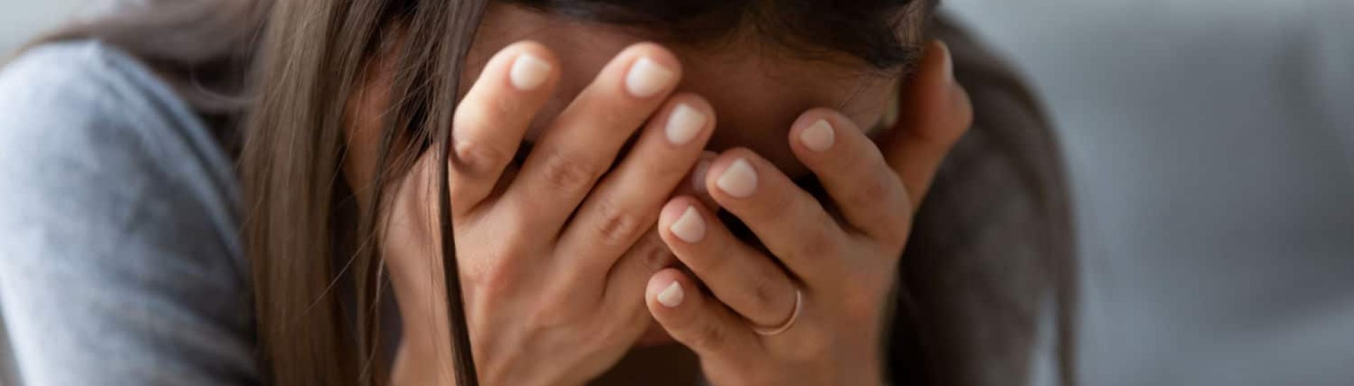 A woman crying due to filing a wrongful death claim